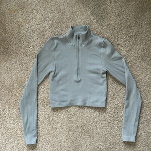 Grey cropped athletic long sleeve half zip top.